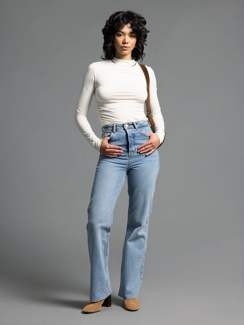 Full outfit with cream ruched top and light denim jeans for an elevated everyday style.