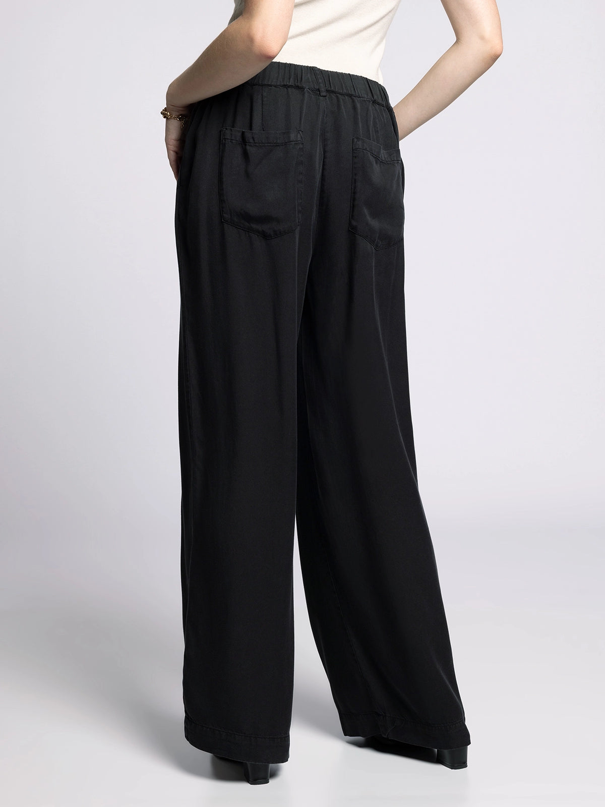 Back view of Gloria Wide Leg Pants in black featuring elastic waistband and relaxed fit.