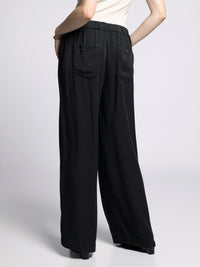 Back view of Gloria Wide Leg Pants in black featuring elastic waistband and relaxed fit.