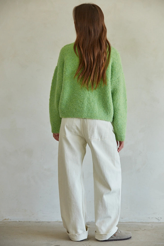Back view of lime green pullover sweater showing soft textured knit and long sleeves.