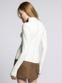Back view of Marisol Mock Neck Top showing long sleeves and fitted back seam design.
