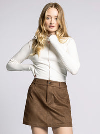 Close-up of Marisol Mock Neck Top highlighting exposed seams and sleek mock neckline.