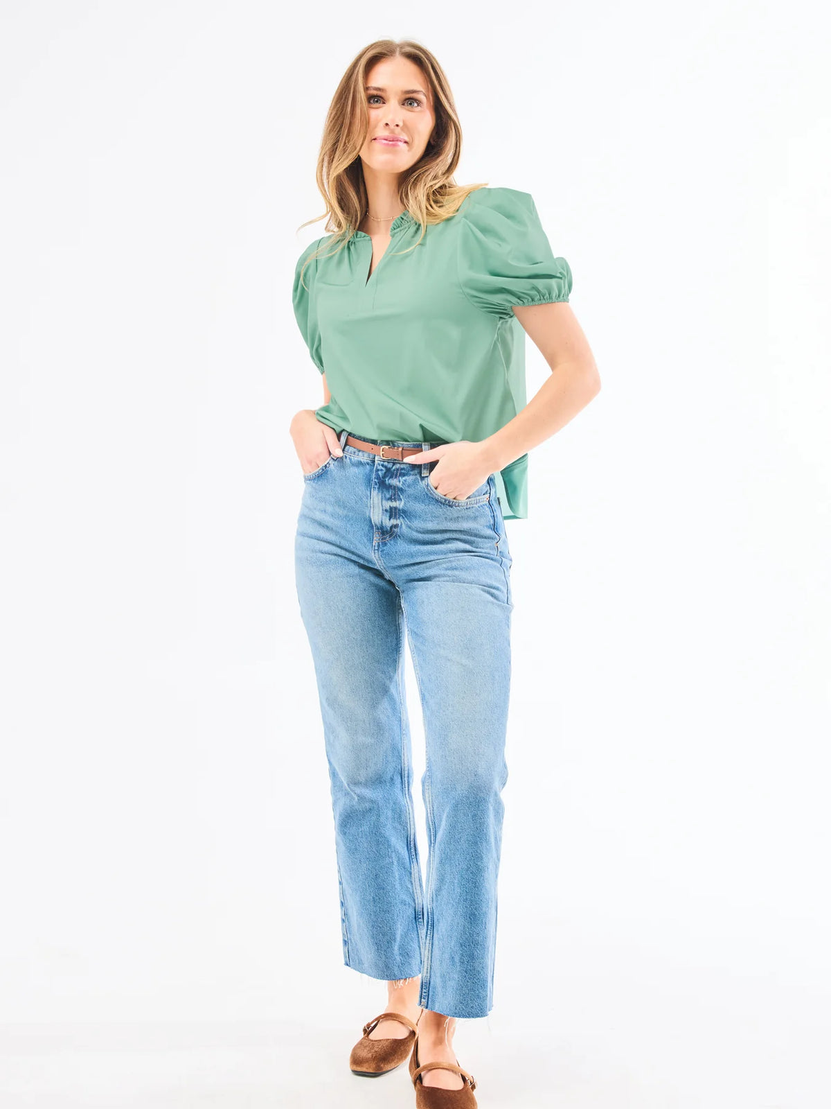 Model wearing Mary Square Lainey Blouse in green paired with light wash jeans and brown flats for an effortless everyday look.
