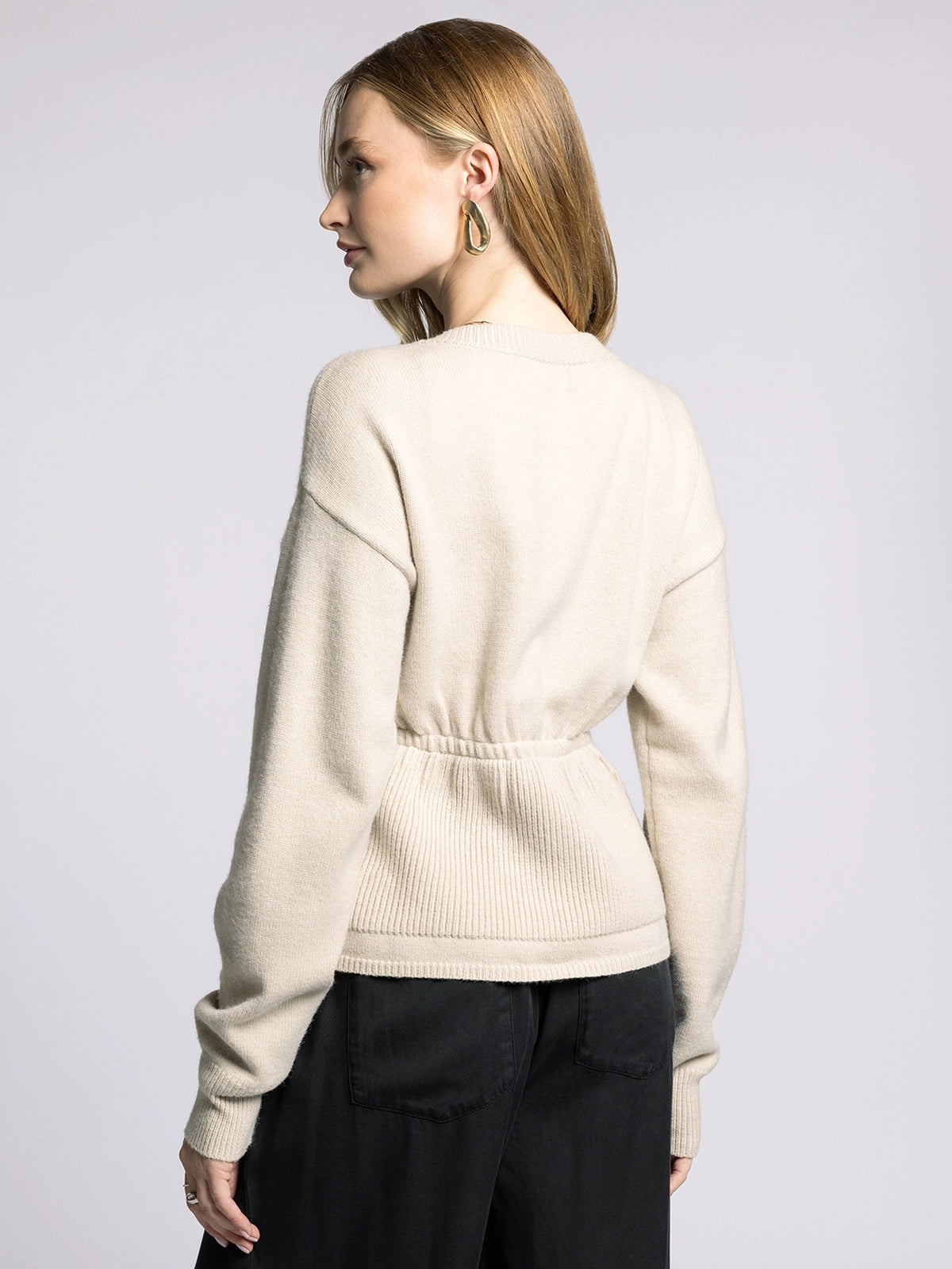 Back view of Michelle Cardigan showing elastic waistband and ribbed detailing for a cinched silhouette.