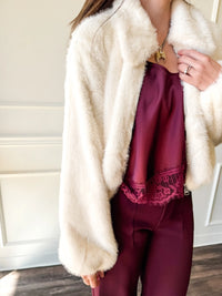 Close-up of the plush faux fur texture and zipper detail on the Steve Madden Evanie coat.