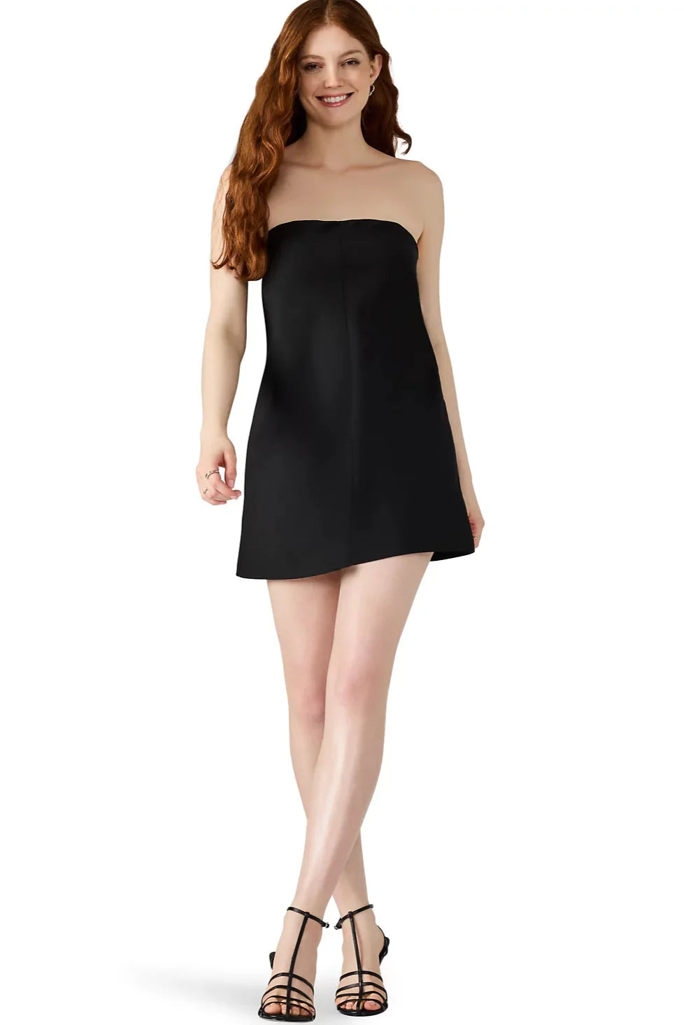 Woman wearing a black strapless dress on a white background