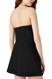 Black strapless dress worn by a model on a white background