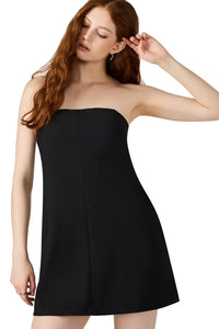 Woman wearing a black strapless dress on a white background