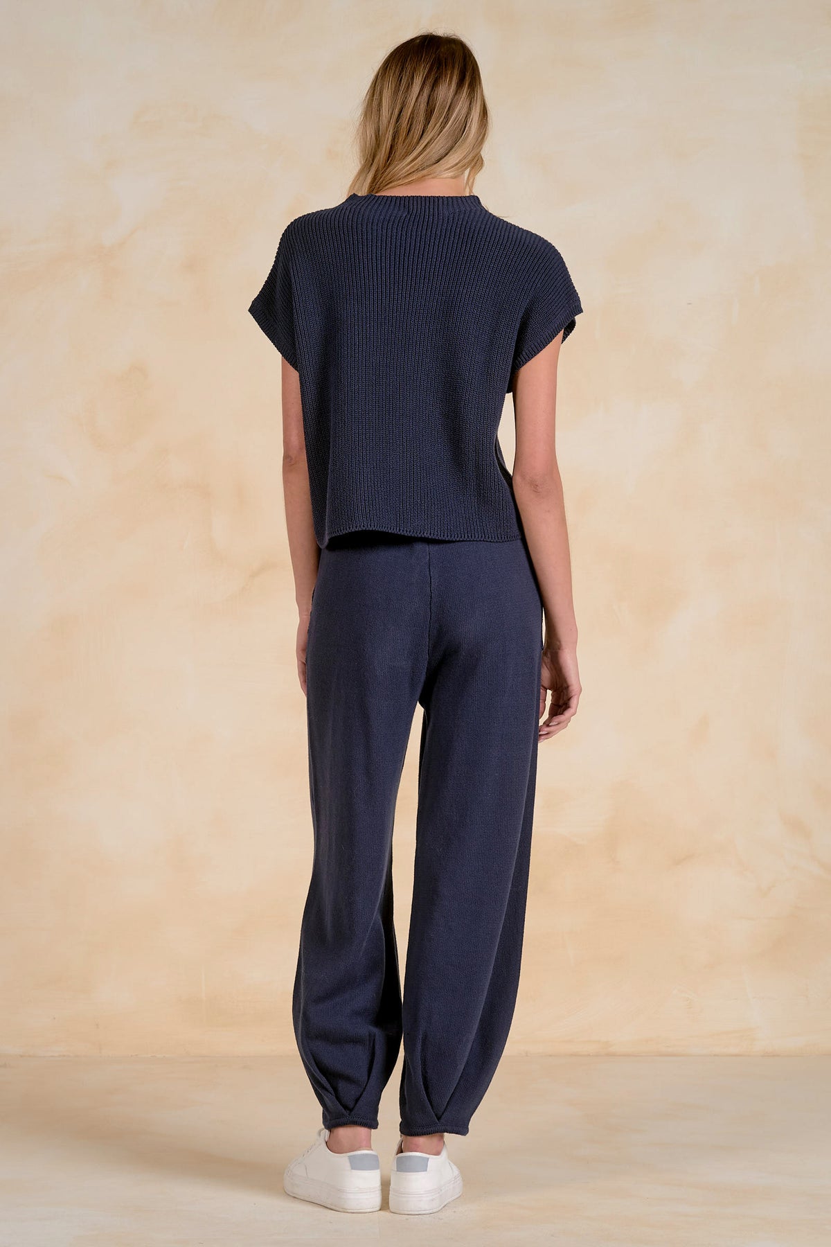 back view navy short sleeve sweater top with chest pocket styled with matching knit pants