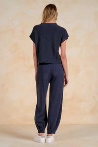 back view navy short sleeve sweater top with chest pocket styled with matching knit pants