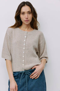 Model wearing beige button-front knit cardigan from Shop Reverie Co.