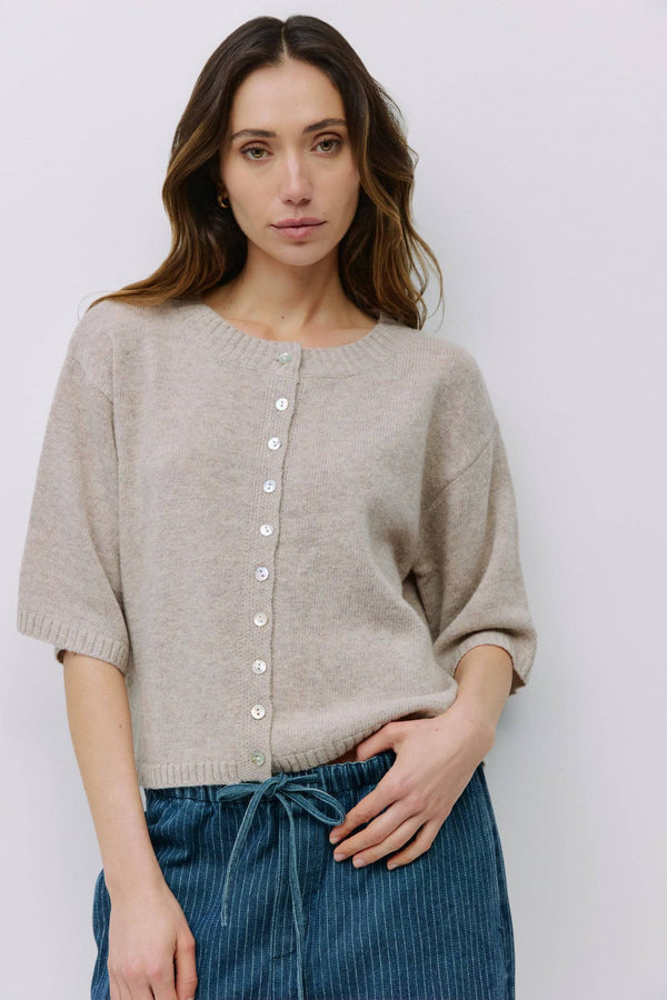Model wearing beige button-front knit cardigan from Shop Reverie Co.