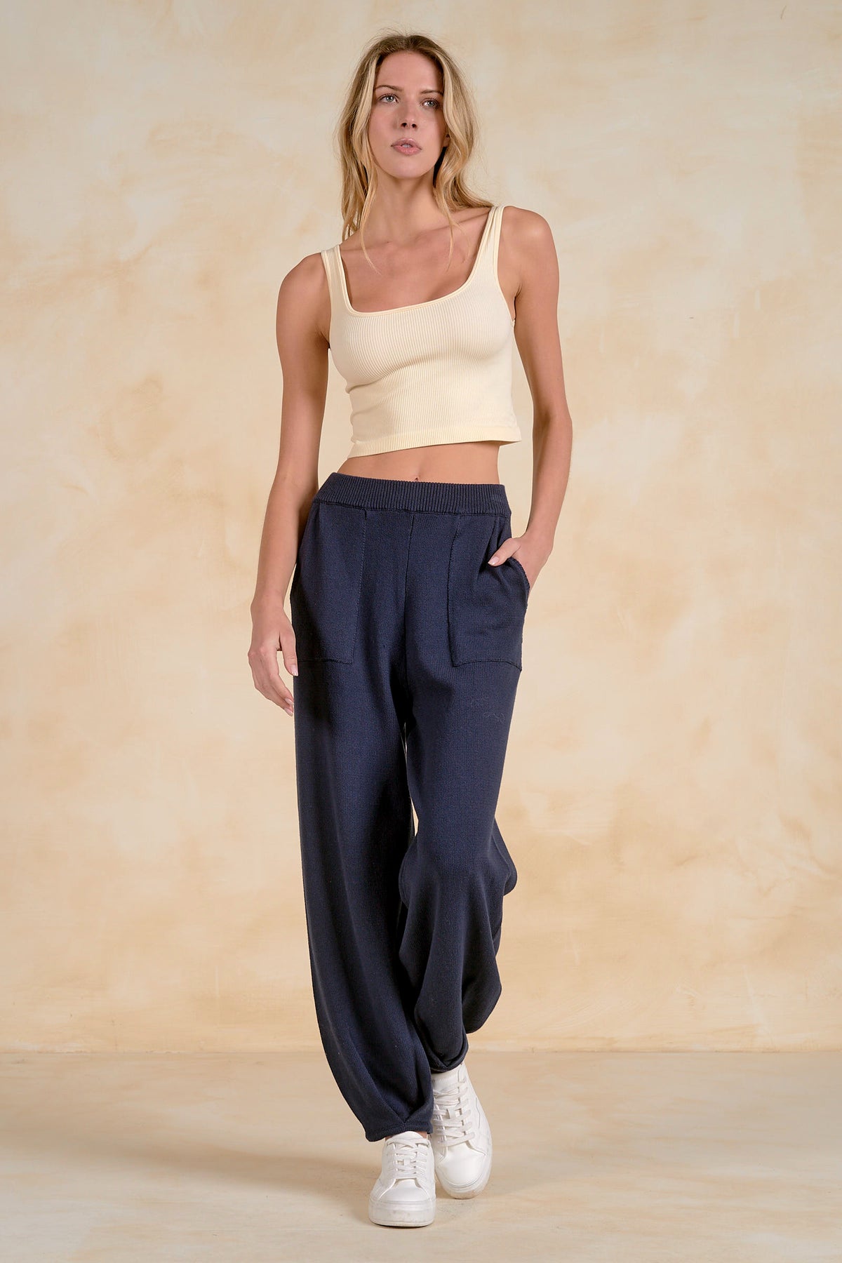Women’s Blaine navy knit lounge pants styled with a cream tank and white sneakers