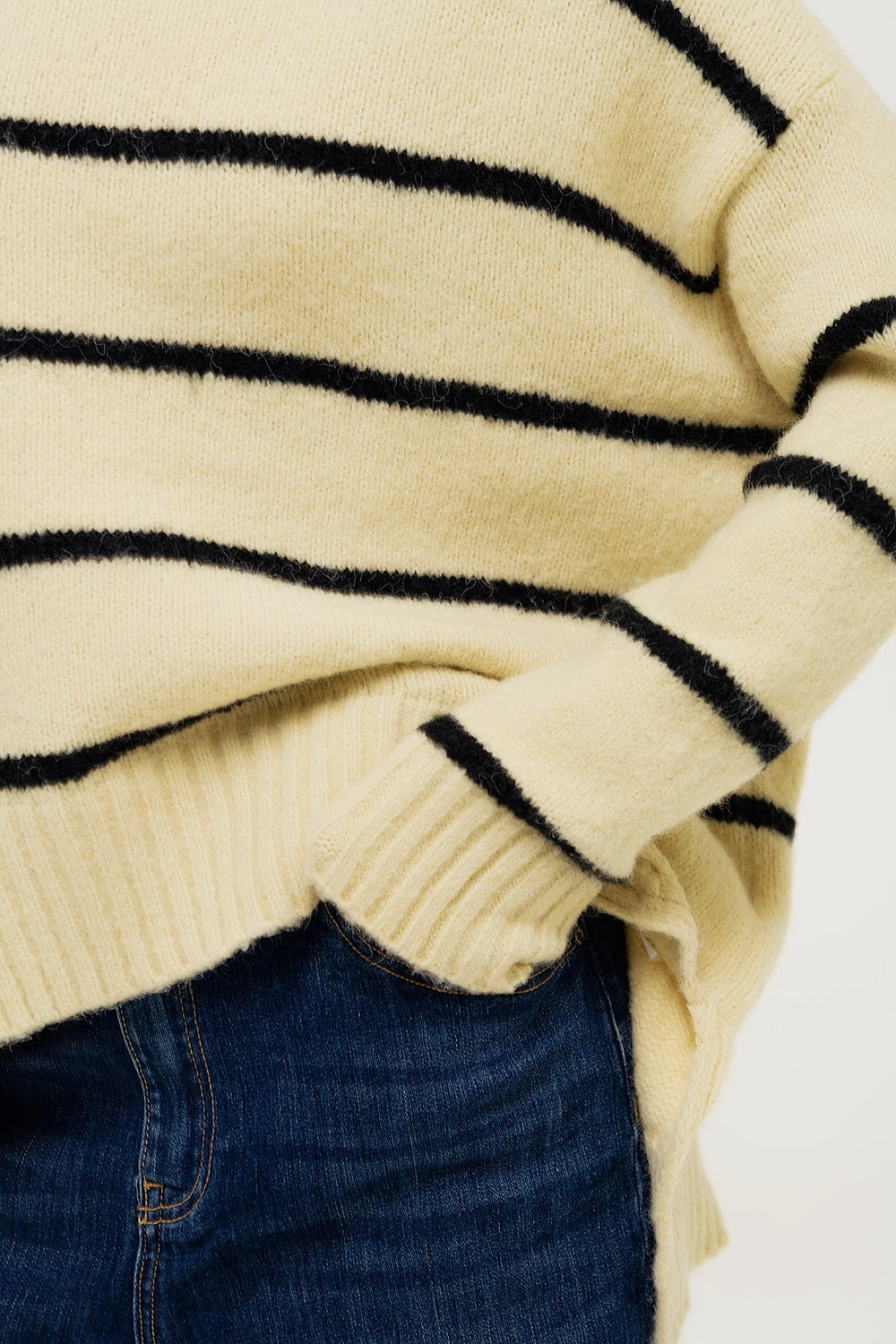Casual fall outfit with oversized striped sweater and jeans, cozy boutique style.