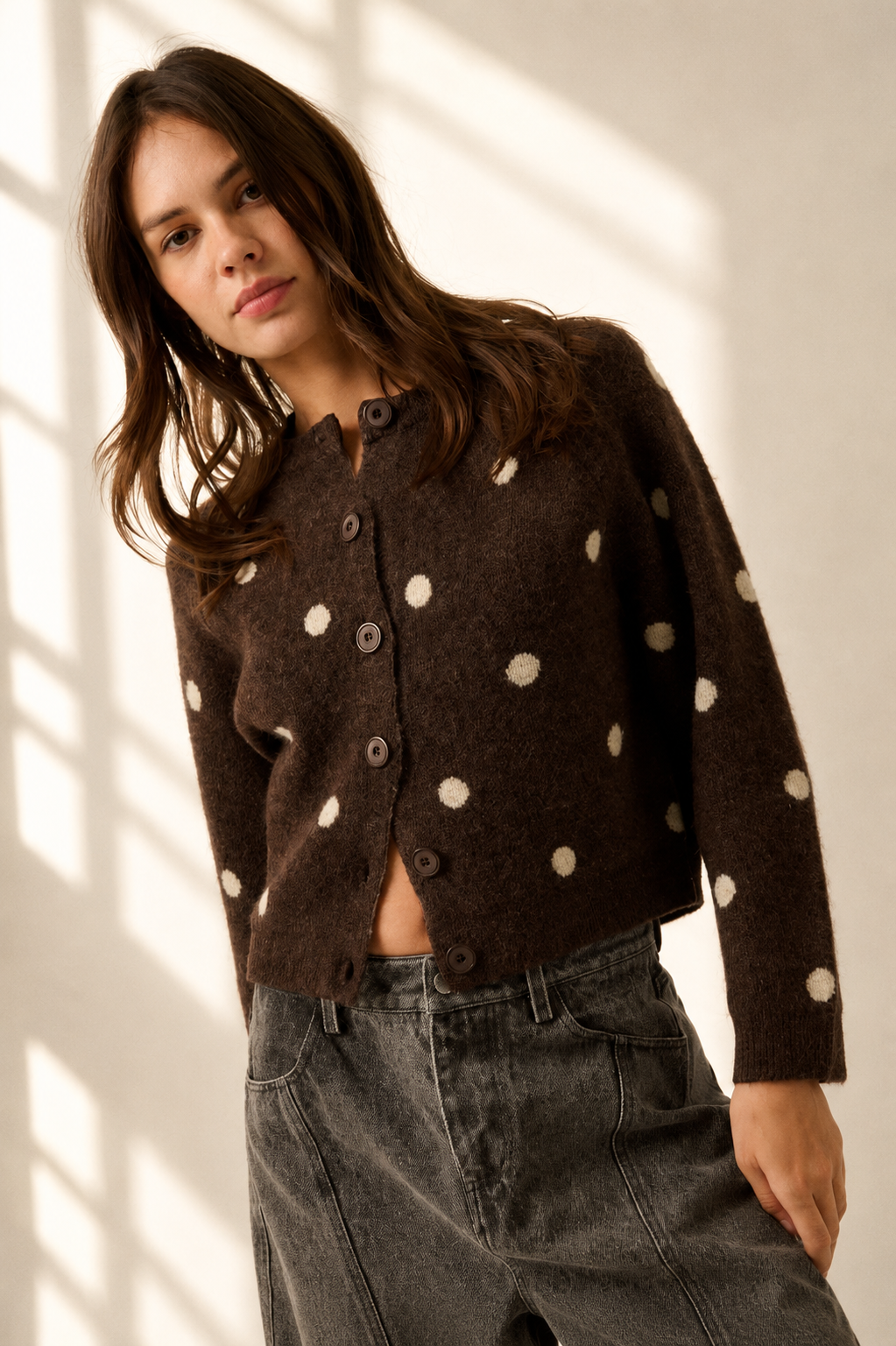 Front view of women’s chocolate brown button-front cardigan with cream polka dots