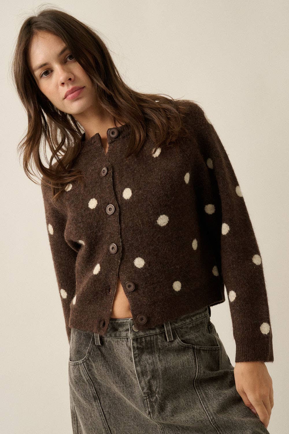 Front view of women’s chocolate brown button-front cardigan with cream polka dots