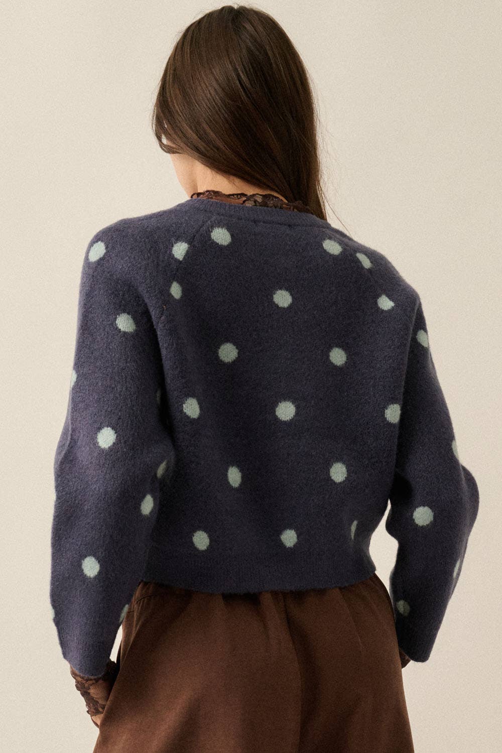 Back view of Carmen Midnight blue polka dot cardigan with cream dot pattern