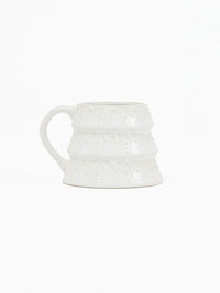 Festive ceramic holiday mug with embossed tree design and milk glaze finish from Shop Reverie Co.