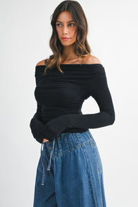 Side profile of Charlotte Top showing off-shoulder neckline and ruched detailing on the sides.