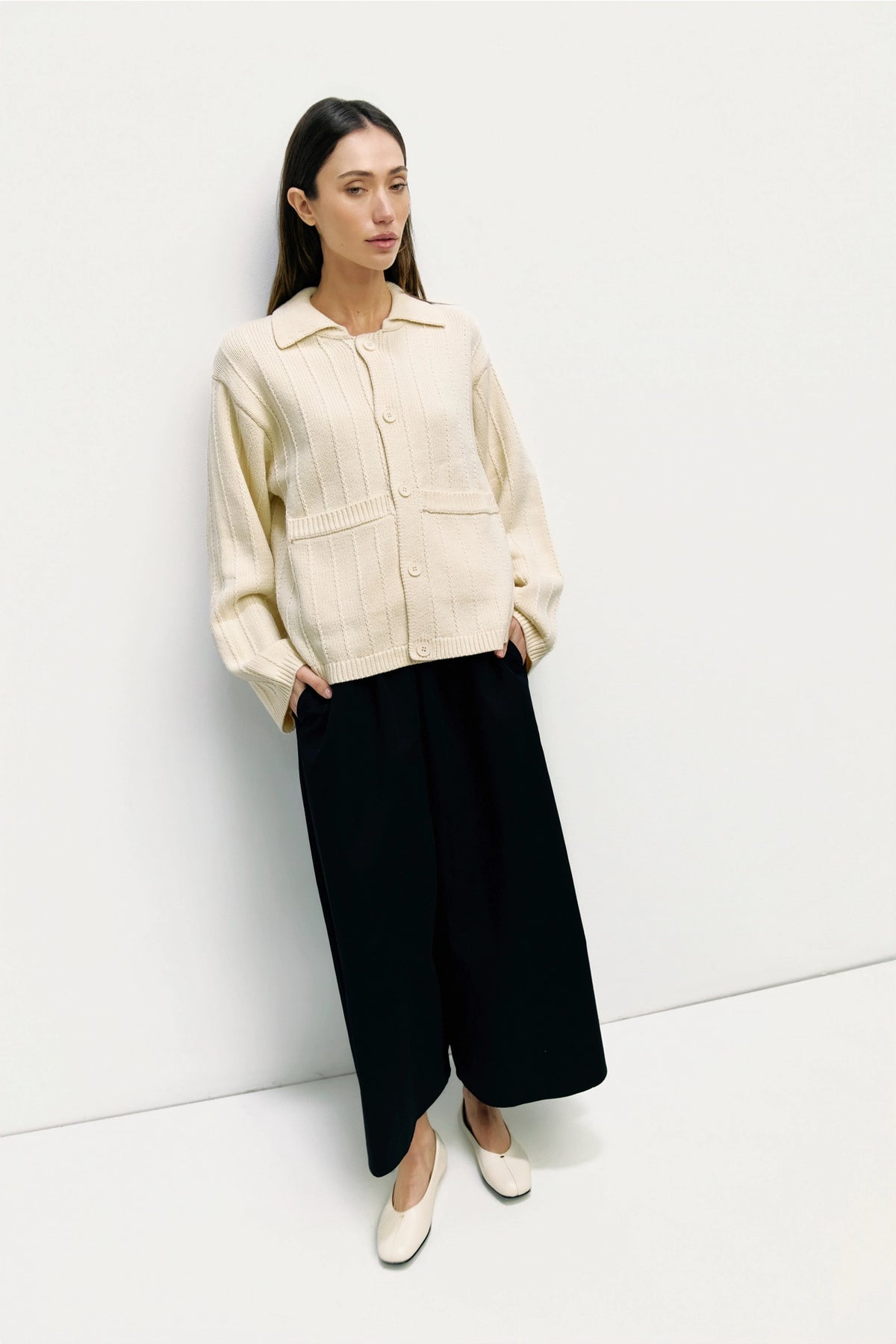 Chic cream cardigan jacket styled with black wide leg pants