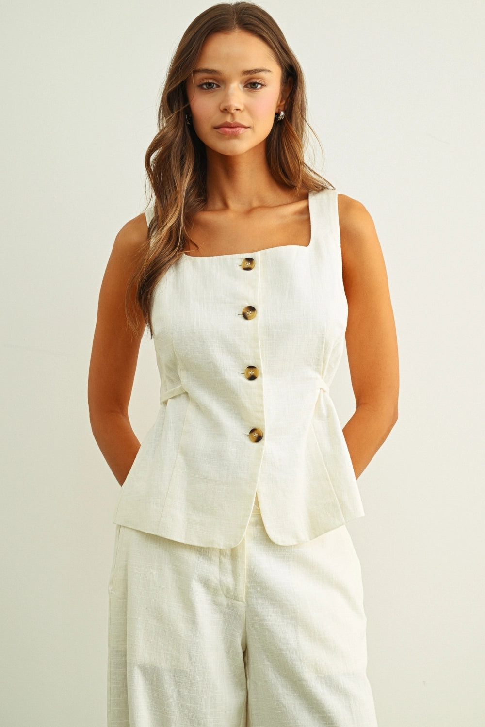 Cream linen button vest top for women with square neckline and tortoise shell buttons front view
