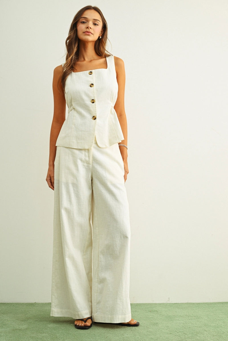 Cream linen vest top styled with matching wide leg linen trousers for summer outfit