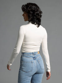 Back view of cream ruched top showing smooth seam lines and fitted design.