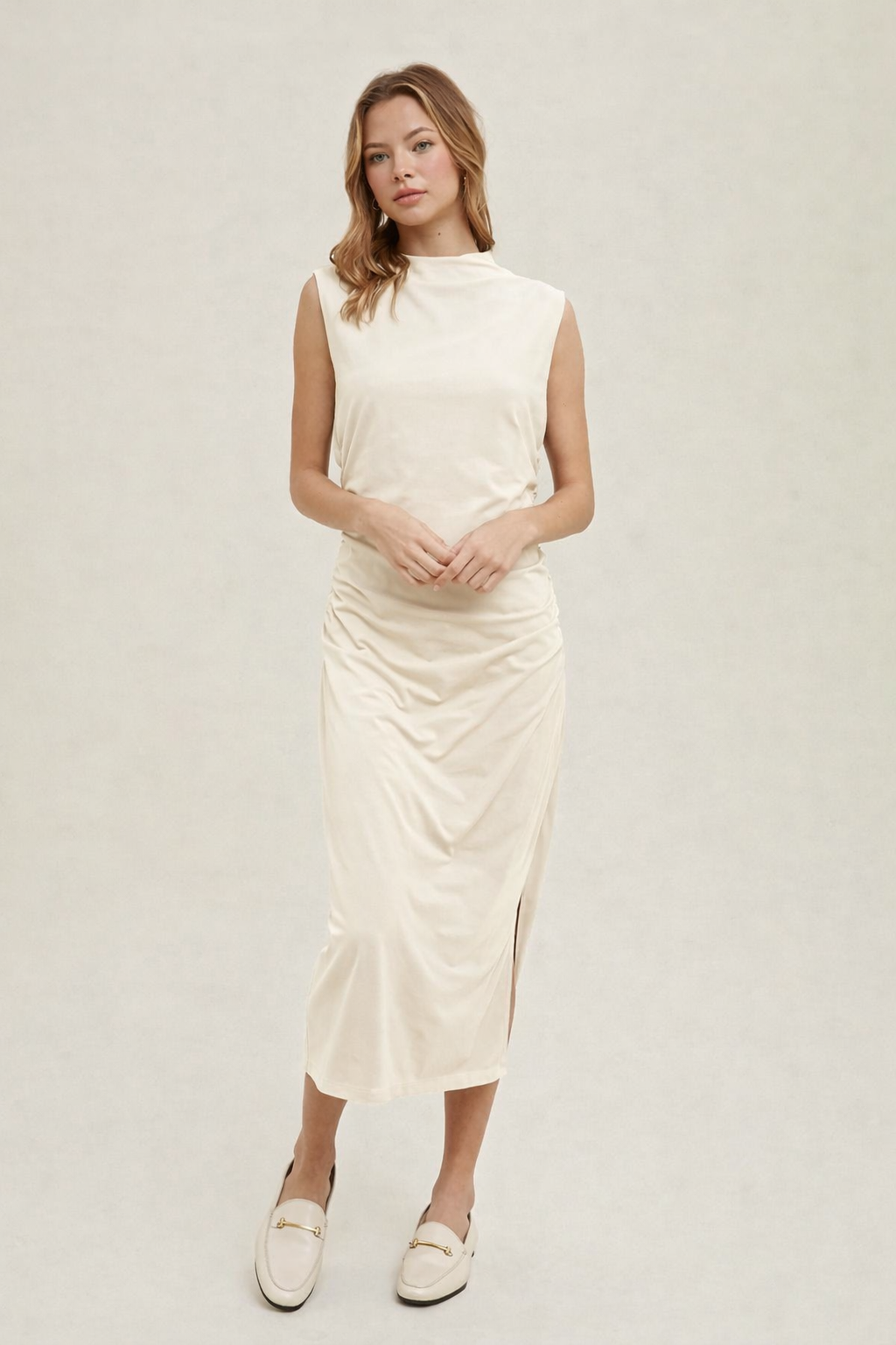 Women’s cream sleeveless ruched midi dress with mock neckline front view elegant minimalist dress