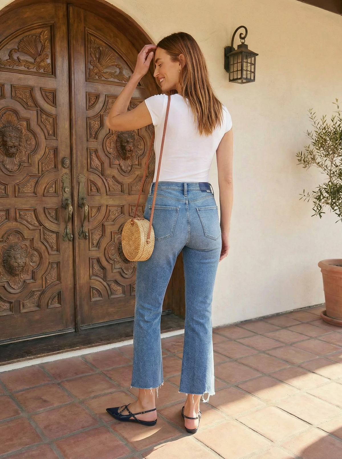 Back view of the Daze Denim Shy Girl vintage flare jeans highlighting the pocket placement, Daze logo tab, and kick flare leg opening.