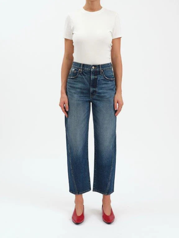 Person wearing blue jeans and a white top on a white background