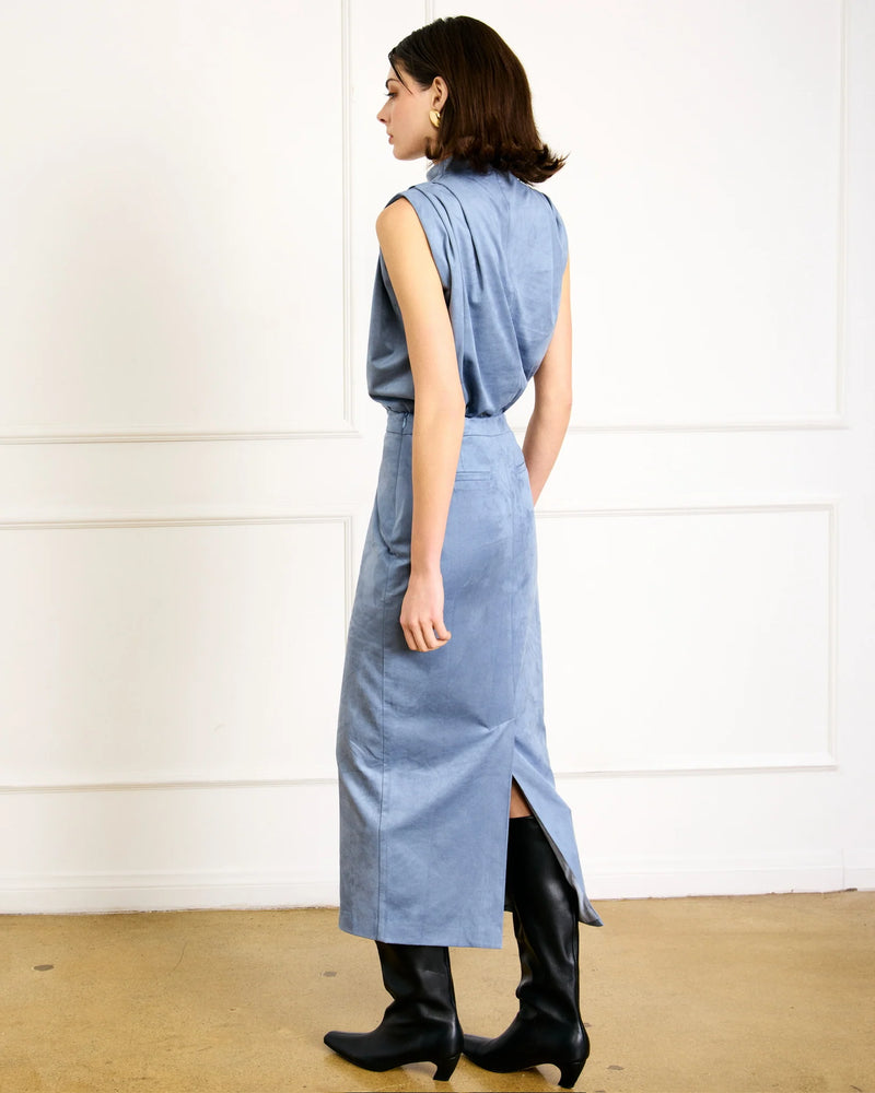 Back view of blue suede pencil midi skirt showing back slit detail.