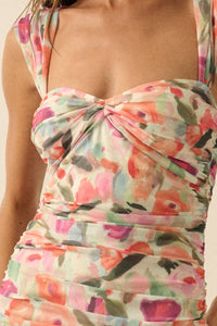 Close-up of the romantic floral print and ruched sweetheart neckline on a lightweight mesh occasion dress.