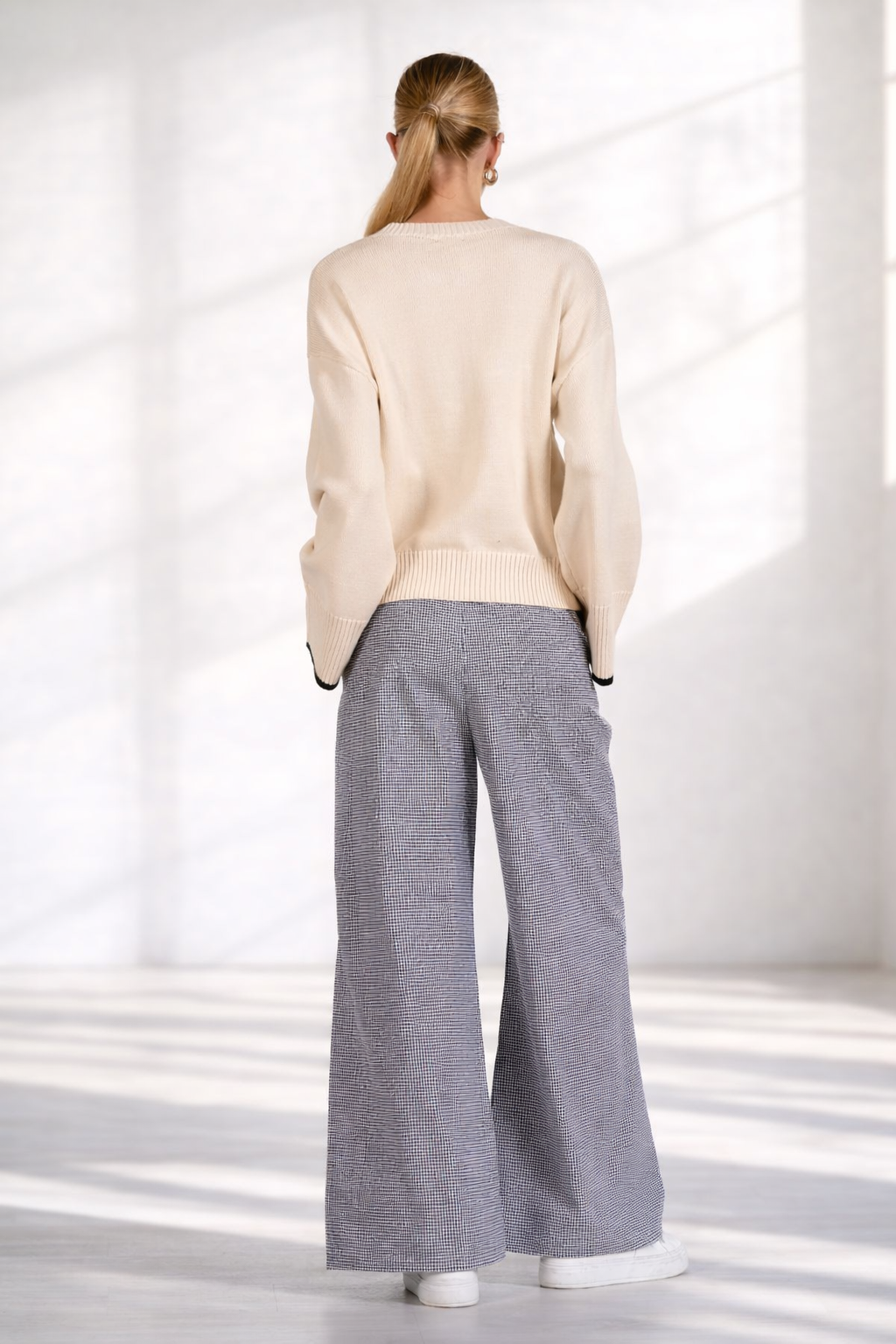Back view of women's black and white gingham wide leg pants