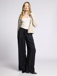 Model wearing Gloria Wide Leg Pants styled with neutral cardigan and tank top for casual chic look.