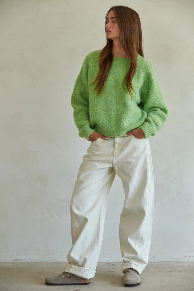 Full outfit view of lime green sweater paired with wide-leg ivory pants for a chic boutique look.