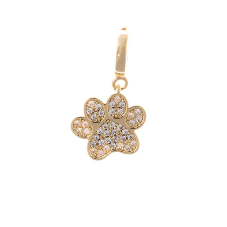 Close-up of the Michelle McDowell gold paw print charm, fully embellished with sparkling pave crystals for pet lovers.