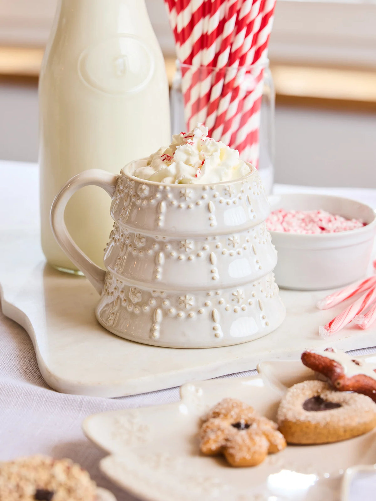 Close-up of 19oz Mary Square White Tree Christmas Mug on marble tray with red candy canes.