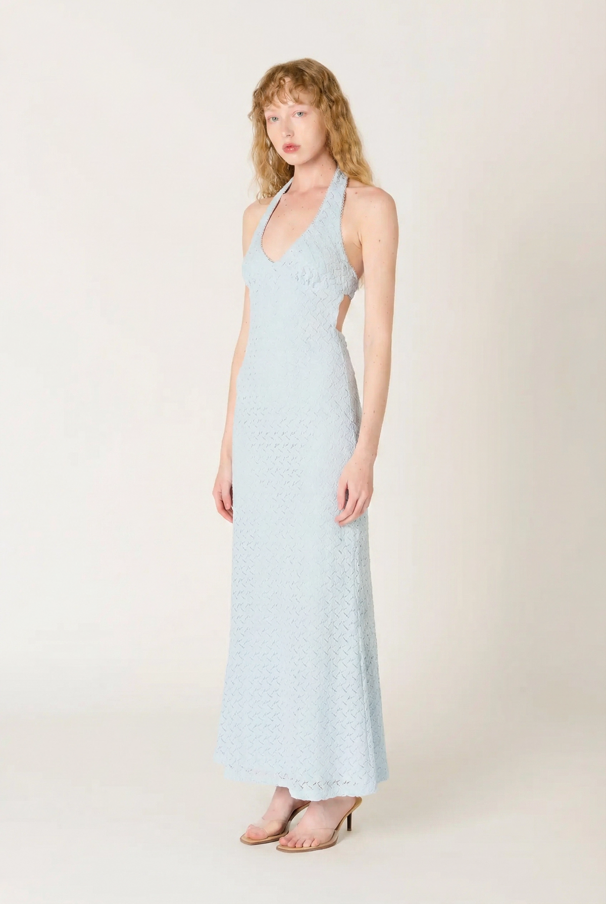 Woman wearing a light blue dress against a white background