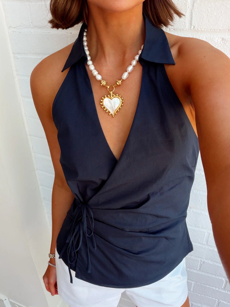 Model wearing the NIA Valle Top in navy, styled for a modern minimalist or coastal chic look.