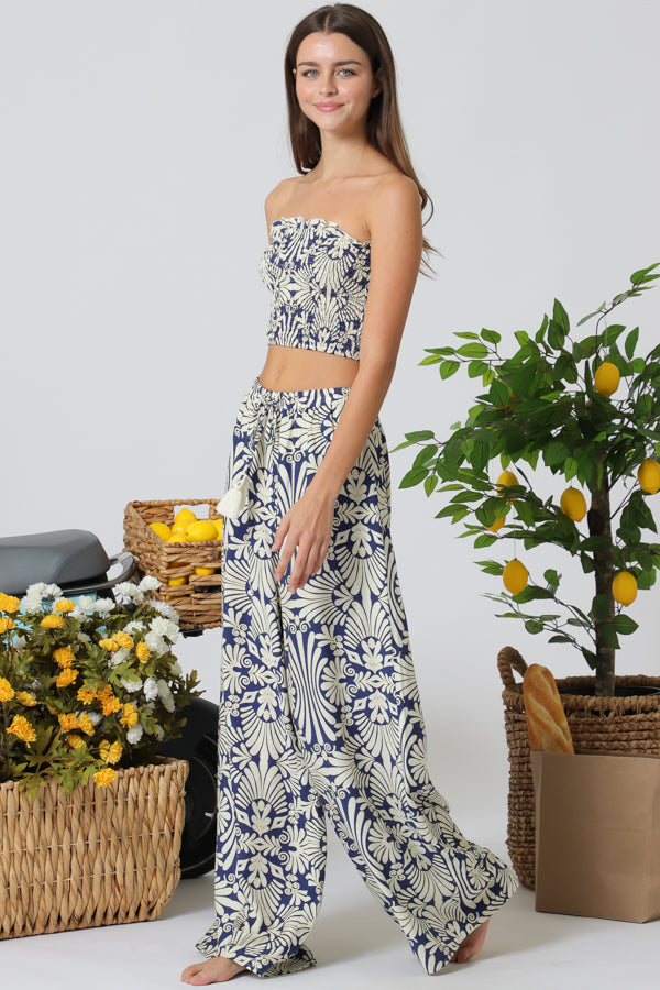 Woman wearing a floral outfit with a white background and decorative elements.