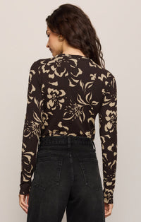 Back View of women in brown floral long sleeve top