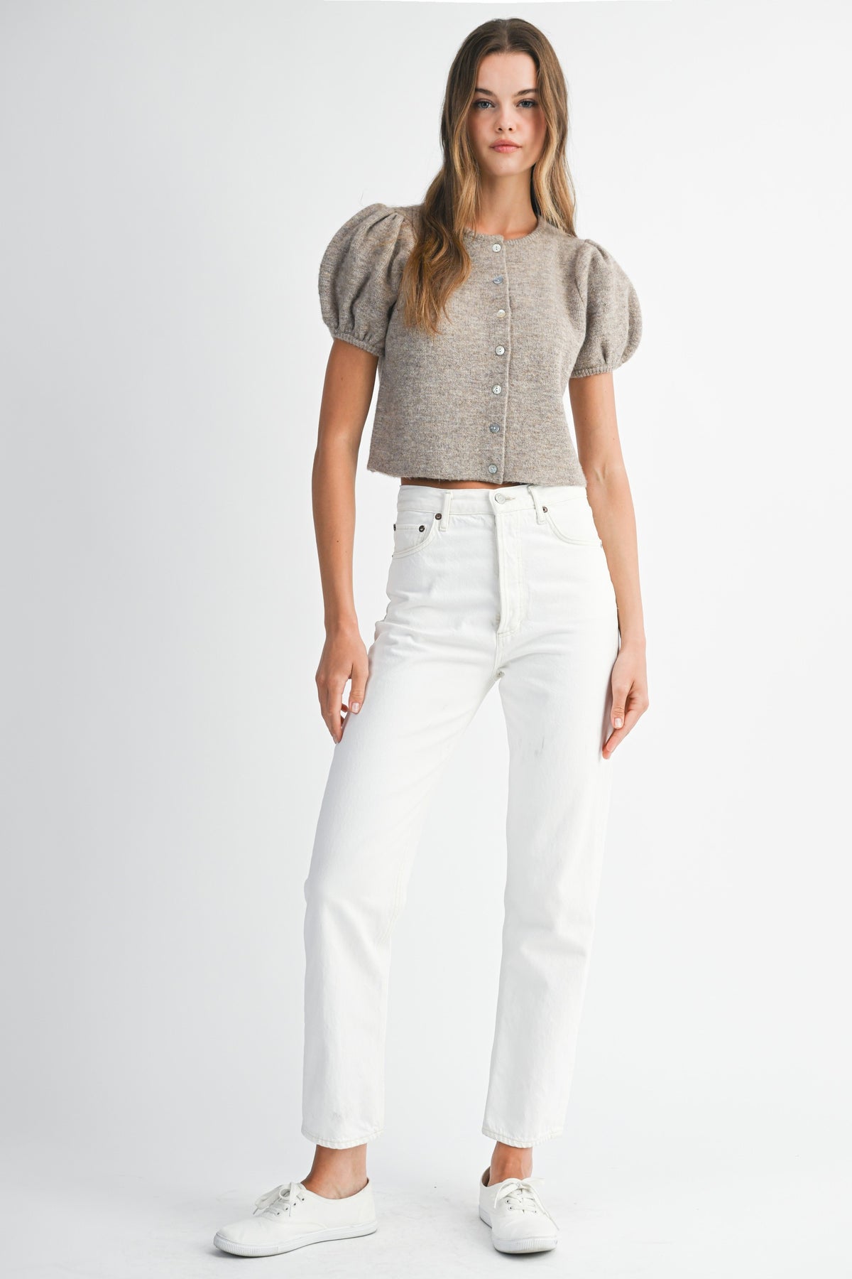 Model wearing Shanty Sweater with puff short sleeves and button-down front paired with white jeans.