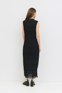 Back view of elegant black maxi dress with sheer overlay detail.