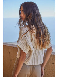 Back view of Steph Crochet Sweater showing detailed crochet knit pattern and cropped ribbed hem.