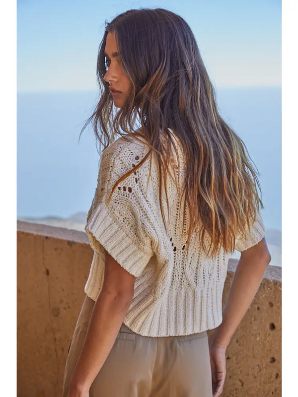 Back view of Steph Crochet Sweater showing detailed crochet knit pattern and cropped ribbed hem.