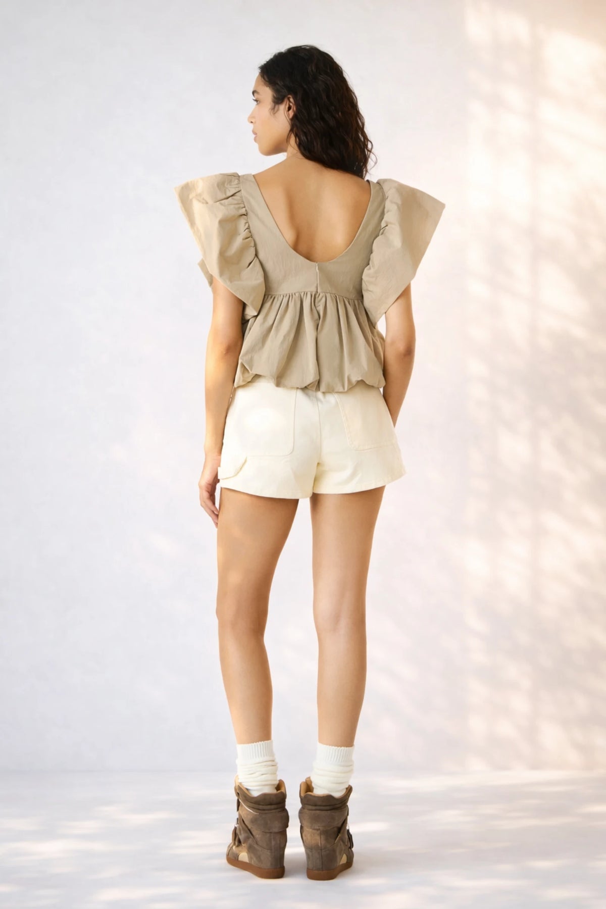 Back view of Steve Madden Saskya blouse khaki with ruffled shoulders and flowy silhouette
