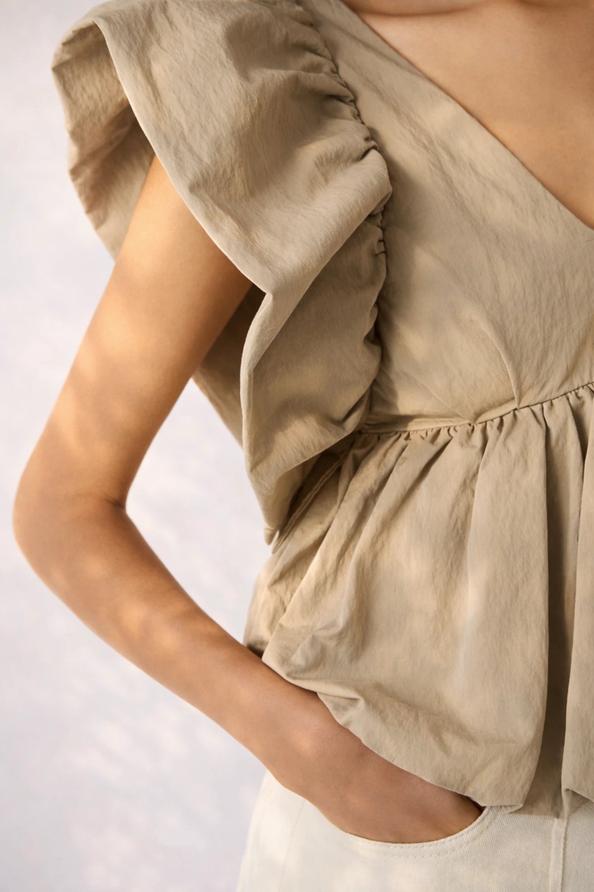 Close-up detail of Steve Madden Saskya blouse khaki showing textured fabric and ruffle sleeve