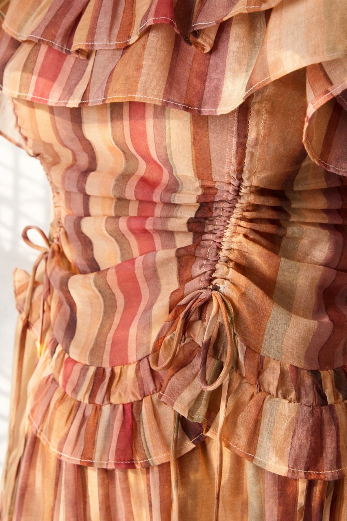 Close-up of Steve Madden Shilloh top showing ruched stitching and tie side detail