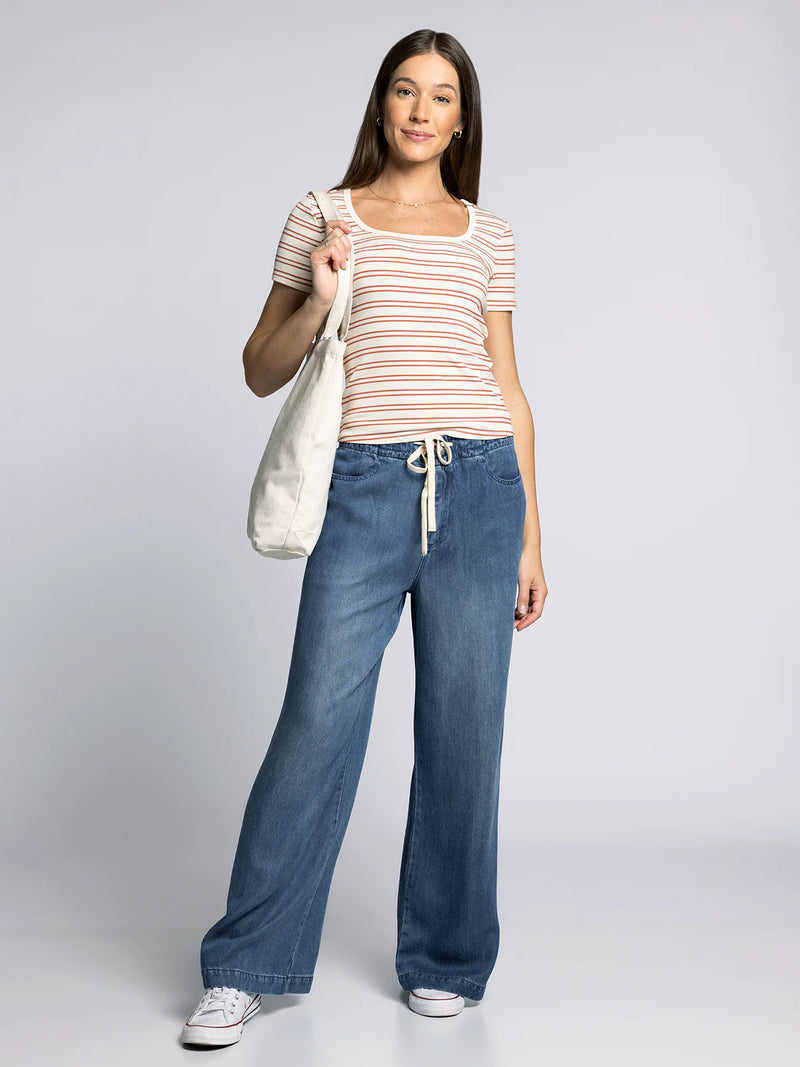 Model wearing Thread & Supply Austin Pants in Sarah Wash — wide-leg denim pants with elastic drawstring waist and relaxed fit.