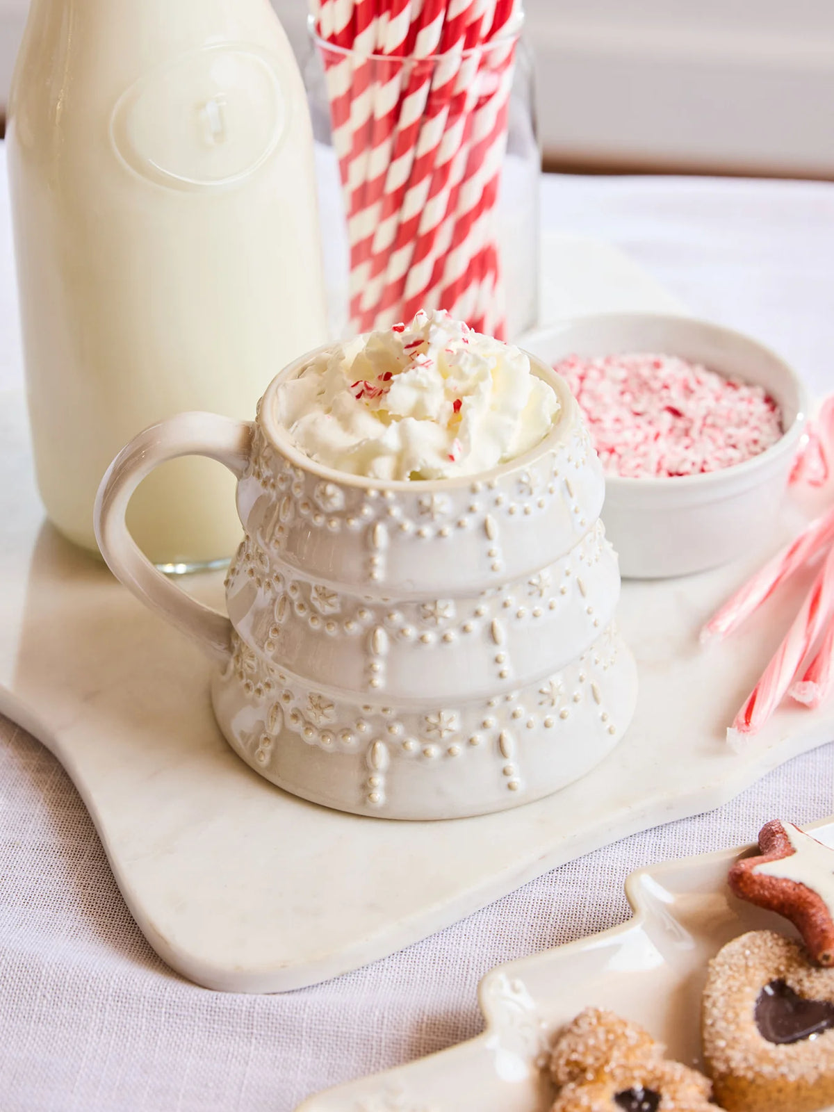 Mary Square milk-glazed ceramic mug styled in cozy Christmas kitchen setting.